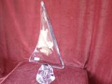 a clear triangle shaped object sitting on a red cloth