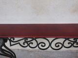 a red table with a black metal base and a red top