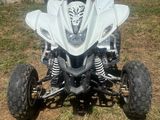 an image of a white quad bike parked in the grass