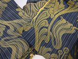 a close up of a blue and gold dress on a mannequin