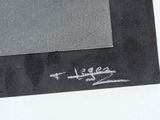 someone is writing on a piece of black paper with a marker