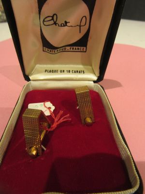 a box with a pair of cuff rings inside of it