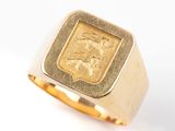 a picture of a gold ring with a lion on it