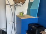 an image of a room with a blue wall and a clock on the wall