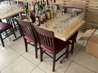 a table with a lot of empty glasses and bottles on it