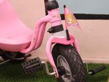 a pink scooter with a flag on the back of it