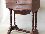 a small wooden table with a drawer on top of it