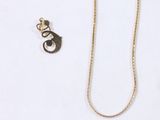 two necklaces and a pair of earrings on a white surface