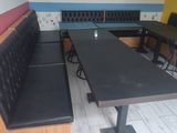 tables and benches are lined up against the wall in a restaurant