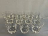 six glasses are lined up in a row on a table