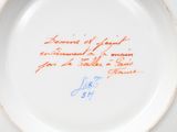 a close up of a plate with writing on it on a table