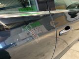 a close up of a car ' s door handle with a sticker on it