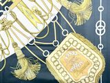 a picture of a scarf with a picture of a crown and a purse