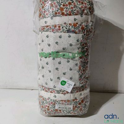 a bag of fabric sitting on a shelf next to a wall