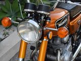 a close up of a motorcycle parked on the side of the road