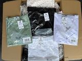 boxes of men ' s clothing are packed in a cardboard box