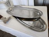 a silver tray and a silver pan on a white table