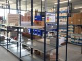 many shelves in the warehouse with boxes on them