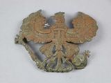 an old bronze brooch with a bird on it