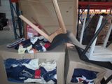 a pile of clothes and a pair of high heels on top of a cardboard box
