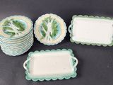 four pieces of green and white dishes and trays on a table