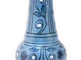 a blue vase with a design on it on a white background