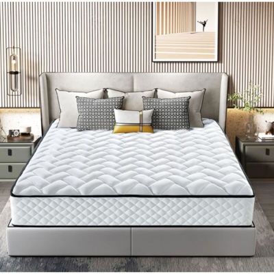 un lit avec un matelas et des oreillers blancs dans une chambre
