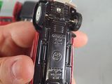 a person holding a toy car in their hand