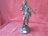 bronze statue of a man holding a dog on a pedestal