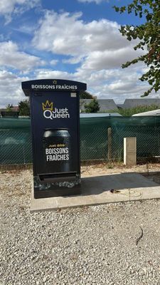 a trash can sitting on the side of the road