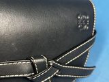 black leather case with white stitching and a bow on the side