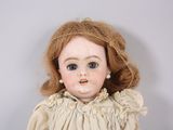 a close up of a doll with red hair