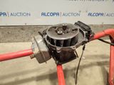 a close up of a red hose with a water pump attached to it