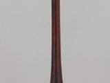 an image of a tall wooden object on a clear surface