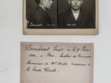 an old photo of two men in suits and ties with a note attached to them