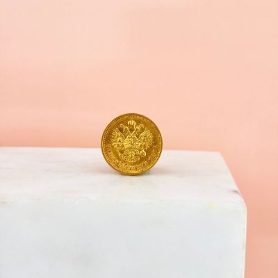 the gold coin is sitting on top of a marble block