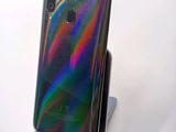 the back of a phone with a rainbow - colored case on a stand