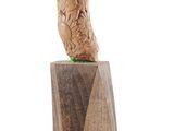 wooden sculpture of a bird on top of a block of wood