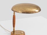 a close up of a table lamp on a white surface