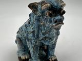 an image of a ceramic figurine of a dog on a white surface