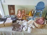 a lot of dolls that are sitting on a bed