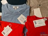 three shirts that have tags on them on them