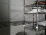many shelves with dishes on them in a kitchen