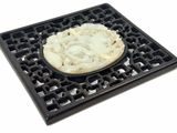 a picture of a carved white and black plate with a picture of a woman on it