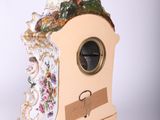 a figurine of a woman sitting on top of a clock