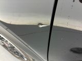 a close up of a car door handle with a screw on it