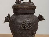a small metal pot with a lid on a table