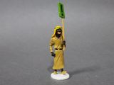 the toy figure is holding a green flag on a gray surface