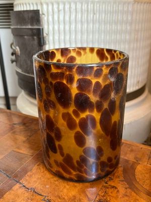 leopard print glass cup on a wooden table in a kitchen