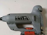 an image of a corded stapler sitting on top of a table